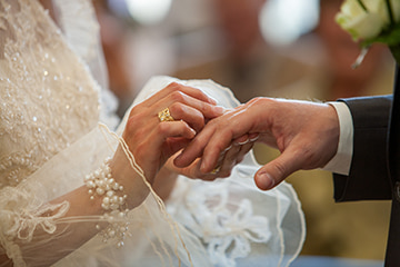 a bride and groom exchange rings at a wedding